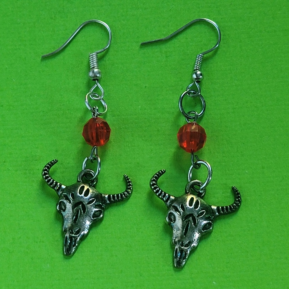 Handmade ram bull skull dangle earrings with a red bead detail grunge punk goth